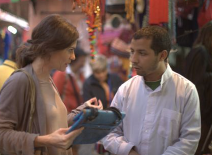 Andrea Bury hält eine blaue ABURY Berber Bag in der Hand und redet mit einem Kunsthandwerker.