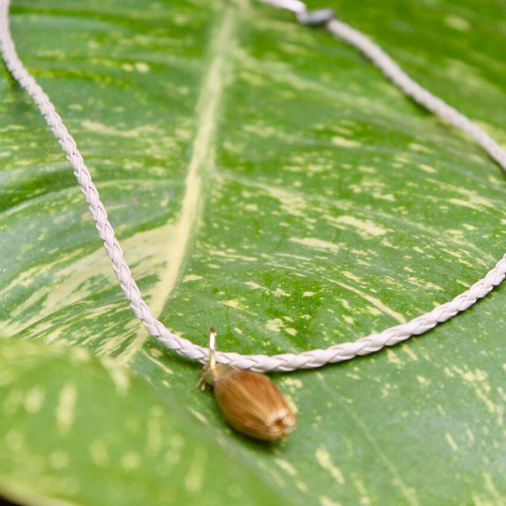 Oval golden grass white necklace by she is from the jungle