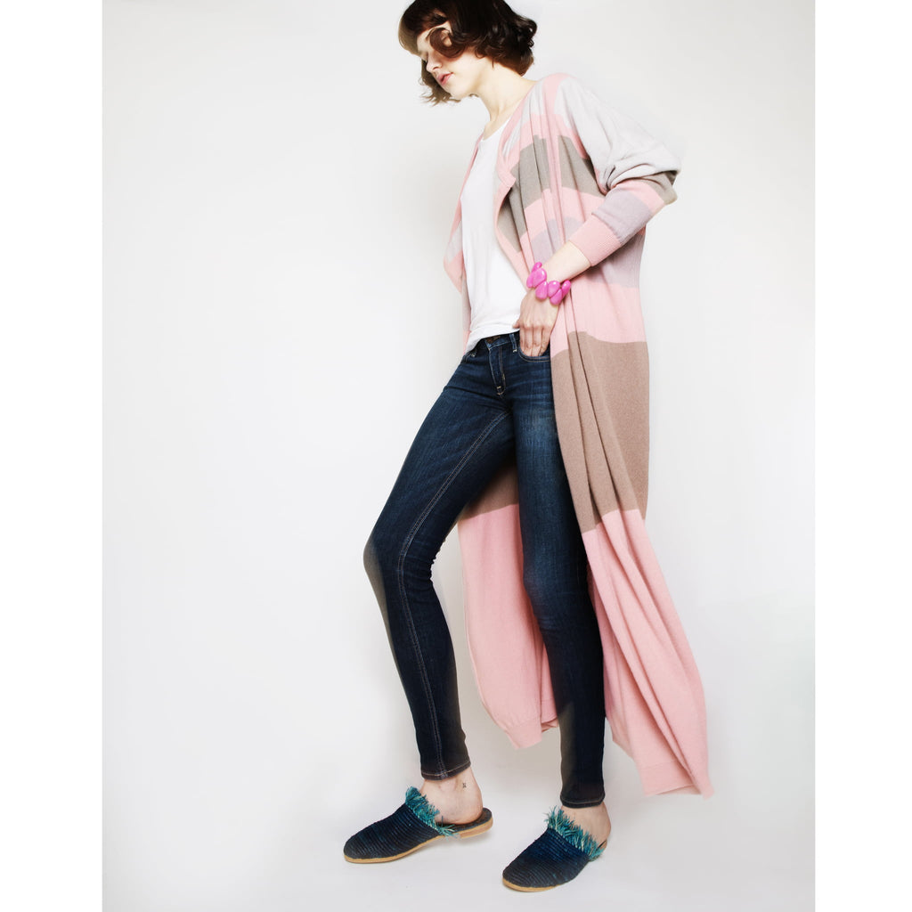 model wearing  abury blue raffia summer slippers with fringes