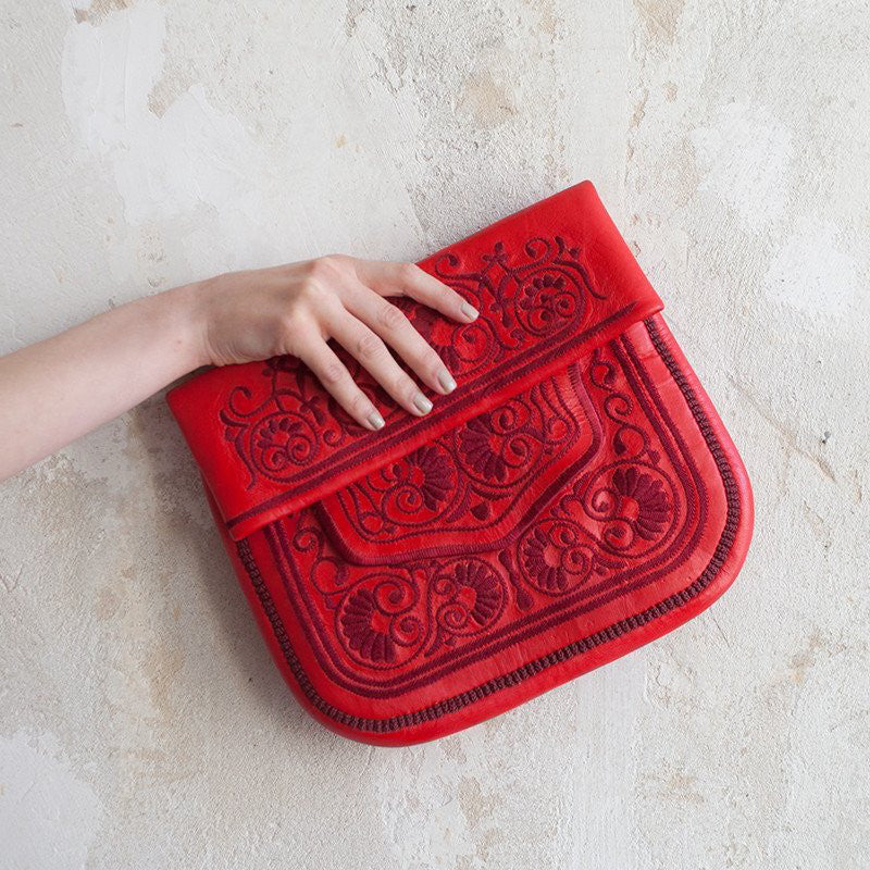 hand holding Red Leather Berber Bag ABURY