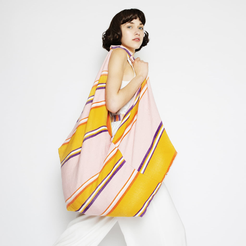Model wearing ABURY XL Hobo Shopper Bag in Pink and Yellow