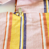 close up of the ABURY XL cotton hobo shopper bag in pink and yellow with cow horn toggle button