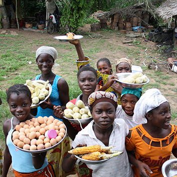 ivory coast women holding plates of food